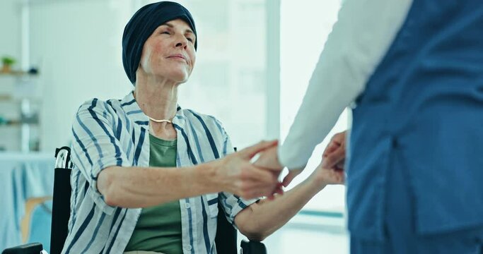 Healthcare, comfort and nurse with senior patient in wheelchair for cancer treatment in hospital. Smile, discussion and caregiver holding hands for support with elderly woman in medical clinic.