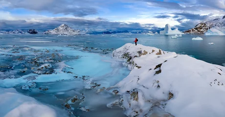 Fotobehang Partly frozen sea and icebergs in Hurry Inlet in Scoresbysund on the east coast of Greenland. © mrallen