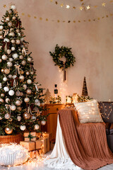 Interior of modern living room with comfortable sofa decorated with Christmas tree and gifts