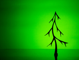 a tree is silhouetted against a green background