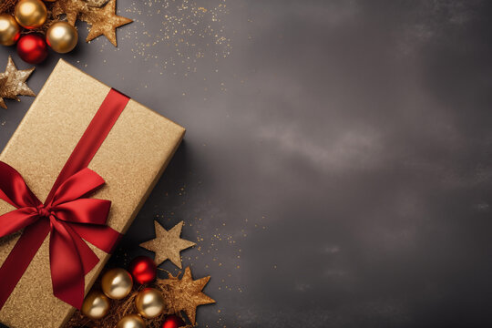 Julklapp med r&ouml;da sn&ouml;ren och stj&auml;rnor i guld mot gr&aring; bakgrund