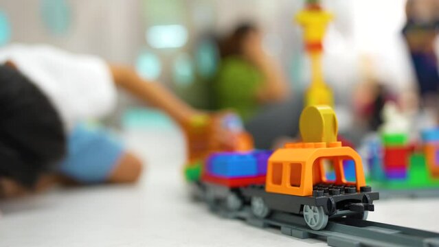 Adorable kindergarten boy enjoying with colorful vehicle toy block building imagination learnning toy