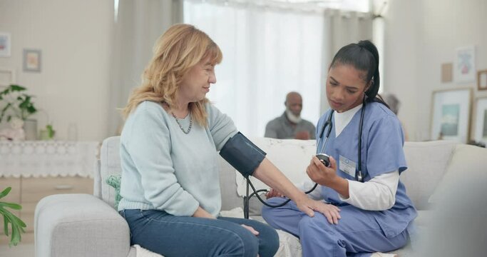 Nurse, appointment and blood pressure with senior woman at nursing home for wellness. Caregiver, service and elderly female for consultation in living room for diabetes with communication for health.