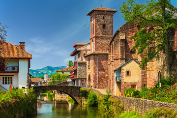 Scenic view of a picturesque French town crossed by a tranquil river. Saint-Jean-Pied-de-Port, France - obrazy, fototapety, plakaty