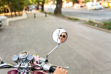 Young Woman Riding Scooter In The City