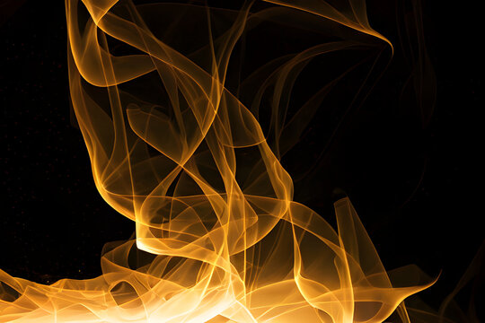 Abstract thing swirls of yellow fire flame and smoke with swirls on black background contemporary modern theme
