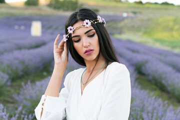 beautiful woman with through in lavender flowers field