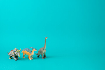 Dinosaurs on a turquoise background. Copy space