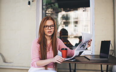 Pensive student with newspaper and coffee