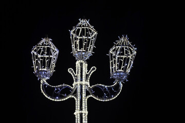 Fototapeta na wymiar Horizontal photo of a glowing pole with LED lamps at night.