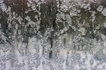 Winter snow-covered window close-up in cloudy weather.