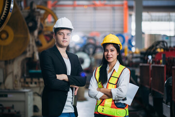 Fototapeta premium Portrait of industrial worker inspecting and check up machine at factory machines. Technician working in metal sheet at industry. Foreman checking Material or Machine.