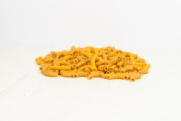 .pasta cones are scattered on the table on a light background