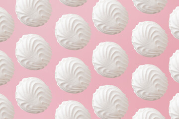 White zephyr marshmallows pattern on light pastel pink background