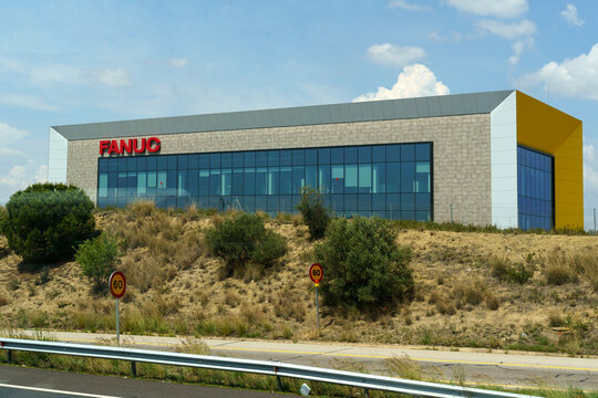 Red Fanuc logo on the wall.