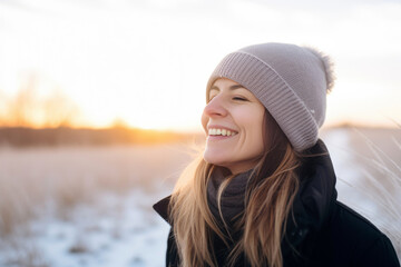 Backlit Portrait of calm happy smiling free woman with closed eyes enjoys a beautiful moment life on the fields in winter time with snow at sunset or dawn - obrazy, fototapety, plakaty