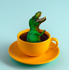 Funny green dinosaur climbs out of  yellow mug with black coffee. Funny minimal art poster.