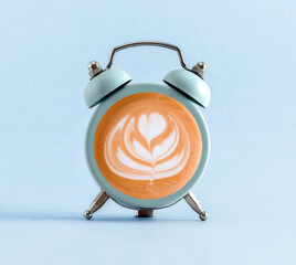 Blue alarm clock with coffee into it.  Minimal art coffee collage.