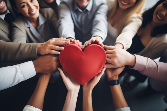 A group of employees forming a heart shape with their hands, creativity with copy space