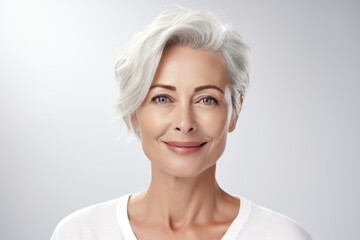 Confident mature woman with silver hair and a warm smile, epitomizing grace and beauty