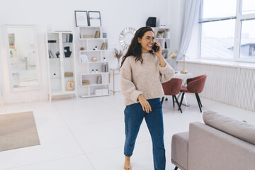 Joyful woman having conversation on smartphone