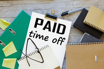 paid time off text on white a4 paper yellow stickers on the table. green folder - obrazy, fototapety, plakaty