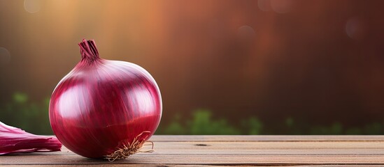 A photo with shallow depth of field captured a wooden background featuring a red onion