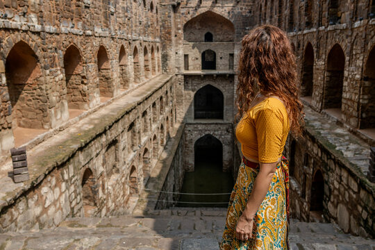 Woman at historic stepwell Agrasen Ki Baoli in Delhi India. 108 steps
