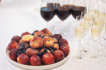 Buffet reception fruit, wines, champagne.fruit plate on wedding table. catering canape assorted fresh fruits, berries and citrus. Fruits for the holidays. Restaurant service at the event.