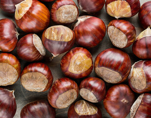 Obraz premium Sweet Chestnuts Top view. Copy space. Pile of ripe chestnuts for food background closeup.