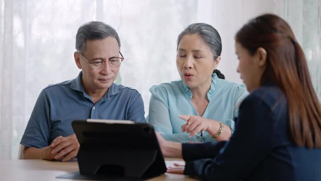 Financial advisor,realtor agent,insurance,lawyer,Manage your retirement fund concept.Financial advisor showing presentation on computer,deal shake hand to happiness Elderly asian couple retirement