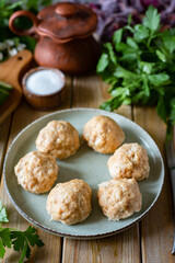 Diet dish for lunch: steamed meat meatballs on a plate. A dish for children: pork meatballs. Vertical photo. Close-up