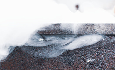 Burning brushwood and leaves in an old rusty barrel