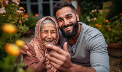 Fototapeta premium Pakistani Grandson and Grandmother Share a Joyful Selfie Moment in Garden