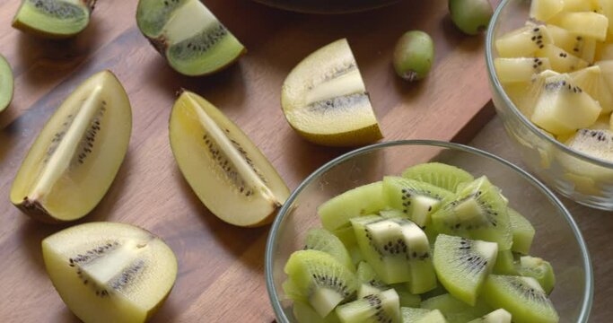 Piecees of different kiwi fruit types. Fresh raw fruits. Table spin.