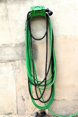 garden hoses and nozzle  on wall bracket
