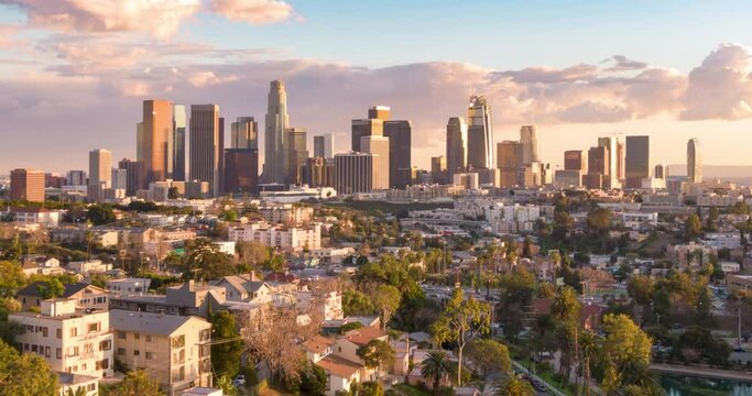 Aerial time lapse or hyperlapse over Echo Park of downtown Los Angeles, California skyline and skyscrapers from above on a sunny day at golden hour before sunset.