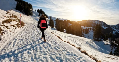 Foto op Plexiglas Dolomieten Young woman walking on snow mountain track during winter time at sunset - Travel and landscape nature concept - Focus on body