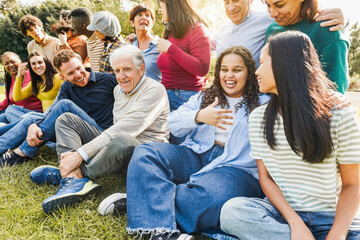 Group of multigenerational people smiling in front of camera - Multiracial friends of different ages having fun together - Main focus on senior man with white hair