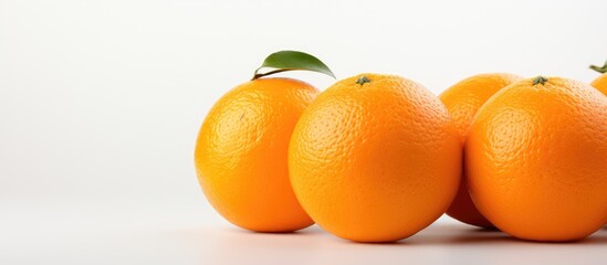 An orange fruit stands alone on a white surface