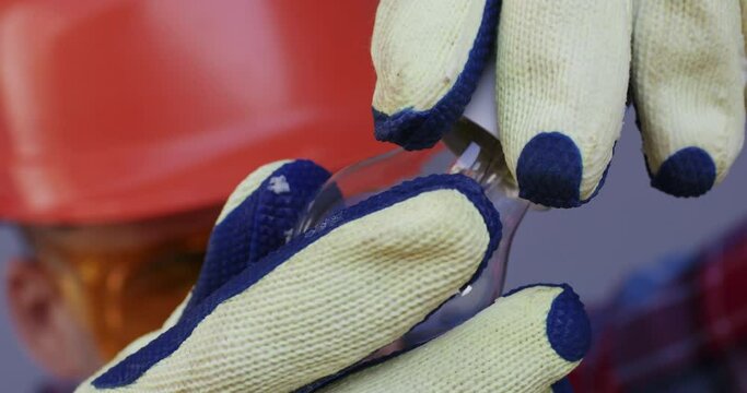 An electrician screws a light bulb into the socket, the light bulb does not work or there is no electric current. The light from the bulb does not appear immediately.