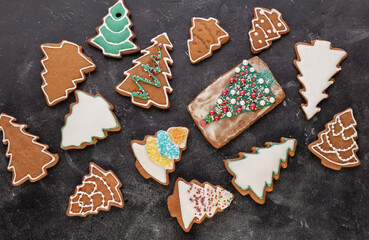 Decorated gingerbread christmas trees on wooden background