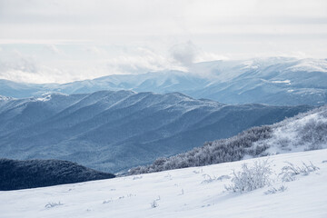 Fototapeta na wymiar Winter mountain landscape. Mountain peaks covered with snow. View from Mala Rawka . Bieszczady Mountains. Poland