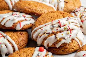 Christmas cookies with white frosting and holiday sprinkles