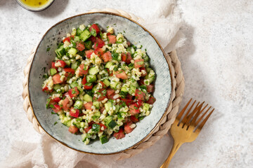 Tabbouleh salad. Traditional middle eastern or arab dish. Levantine vegetarian salad with parsley, mint, bulgur, tomato.