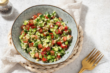 Tabbouleh salad. Traditional middle eastern or arab dish. Levantine vegetarian salad with parsley, mint, bulgur, tomato.