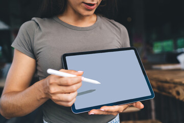 Crop woman explaining information on tablet with stylus