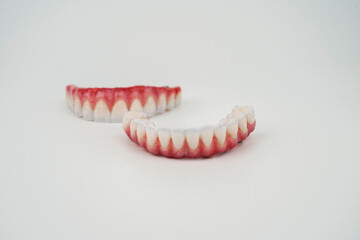Excellent composition of upper jaw and lower jaw prostheses on a white background © Umutcan