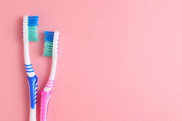 Different toothbrushes on a colored background. Dental care, oral health.