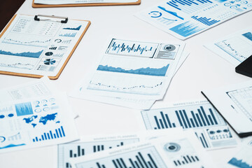 Piles of business intelligence paper or BI financial report and financial data visualization on...